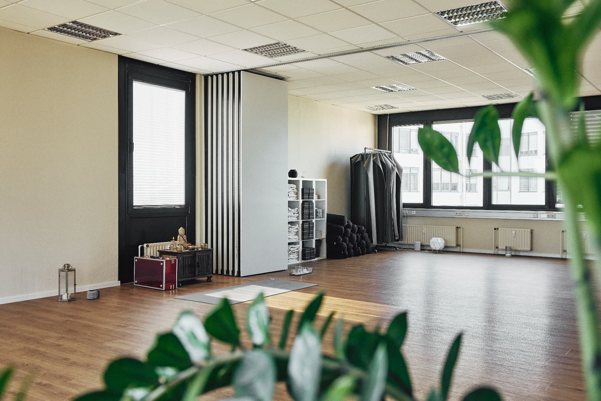 A quiet lounge on the code_n campus with soft light and plants in the foreground
